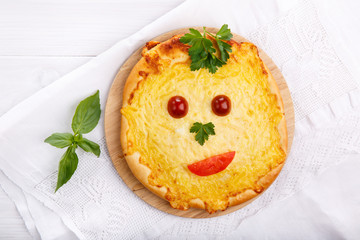 Flat bread with cheese. Whole flatbread pizza on white table.