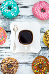 Coffee and colorful donuts.