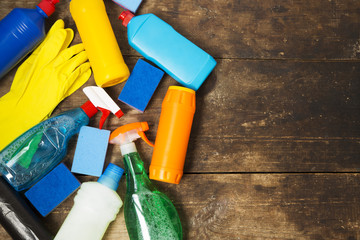 Cleaning products on wooden background. House cleaning concept. Top view. From above. Copy space.