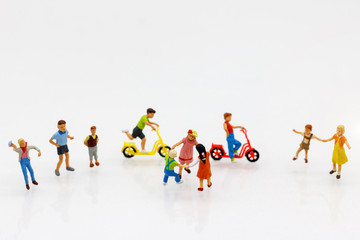 Miniature people children playing on Bicycle, happy family day concept.
