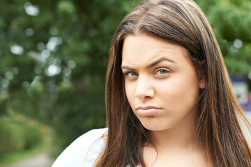 Fototapeta premium Head And Shoulders Portrait Of Serious Teenage Girl