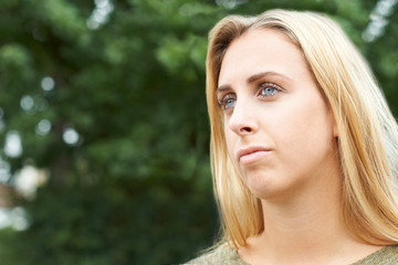 Naklejka premium Head And Shoulders Portrait Of Serious Teenage Girl