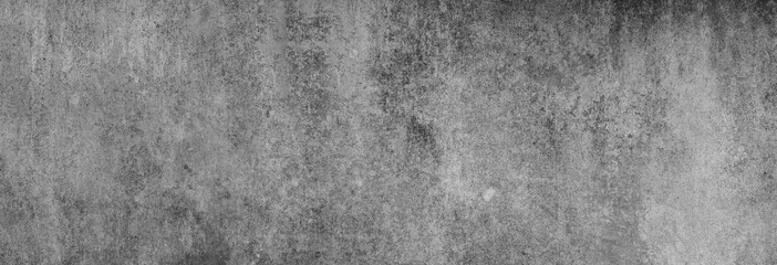 Beton-Textur in fast grau-schwarz in XXL-Größe als Hintergrund, auf die Betonwand fällt leichtes...