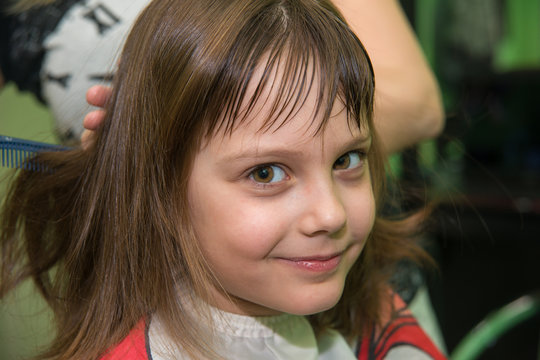 Little Girl Getting Haircut in Salon