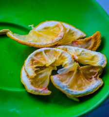 still life which contains a green plate and lemon slices