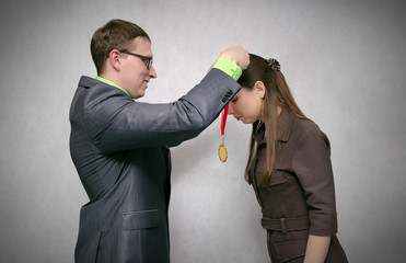Rewarding a person with a gold medal for first place and victory at competitions or business...