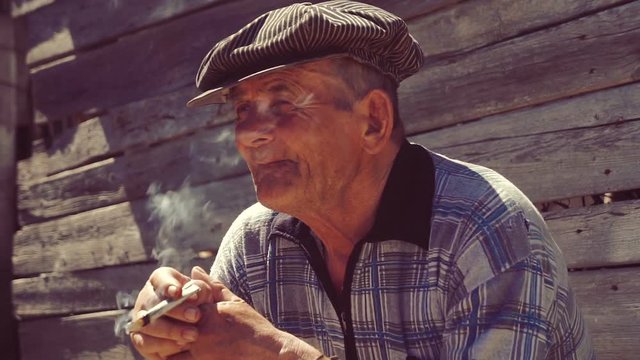 Farmer smoking a cigarette on the farm , straw cigarette