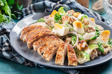 Healthy caesar salad with chicken, eggs and croutons