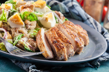 Healthy caesar salad with chicken, eggs and croutons