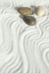 Fototapeta na wymiar Pebbles in the sand, a background of appeasement