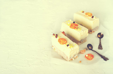 White cakes and two teaspoons for mother, woman or girlfriend on concrete background. Free space for your text.