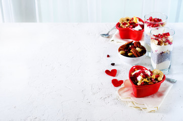 Obraz na płótnie Canvas Healthy breakfast - pomegranate, yogurt, granola parfait on white concrete background. Romantic time.