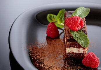 Chocolate cake with raspberry and mint .