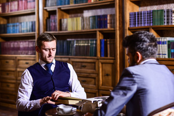 Intelligent elite and education concept. Men in suit with bookshelves