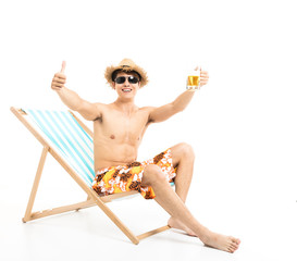 Relaxed man sitting in lounger chair and drinking beer