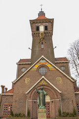Fototapeta na wymiar Jesus Christ Statue In Front Of A Church Called Schuilkerk De Hoop At Diemen The Netherlands
