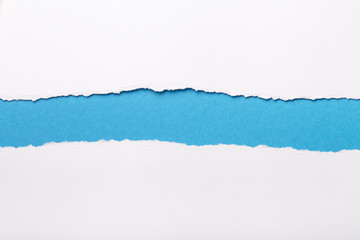 Fototapeta premium Ripped white paper with colored background with space for text