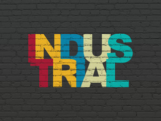 Obraz premium Manufacuring concept: Painted multicolor text Industrial on Black Brick wall background