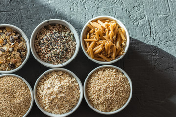 Bowls with whole grain carbohydrates, oats, brown rice, seeds, quinoa and whole grain pasta. Whole grain cereals