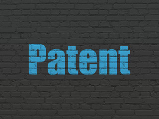 Fototapeta premium Law concept: Painted blue text Patent on Black Brick wall background