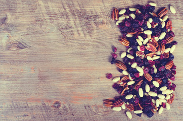Dried fruits assortment on dark background, health food concept. Toned