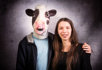 Girl and boy with  horse head. Strange couple concept. - obrazy, fototapety, plakaty
