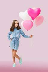 Happy cute little girl  with pink balloons  on a pink background. mother's day. Children's funny birthday party. 