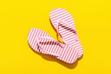 Pink Beach flip flop on yellow background