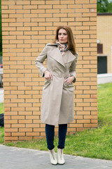 Charming young woman in coat with long brunette hair