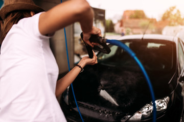 Woman washing the car.