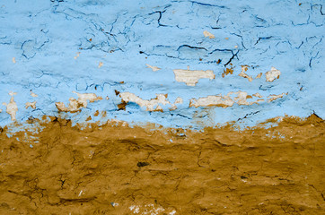 texture background abstraction clay wall in cracks blue and brown