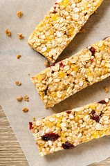 Granola bar with nuts, berries and oat flakes on white background. Healthy food. Diet and vegetarian dish. Top view.