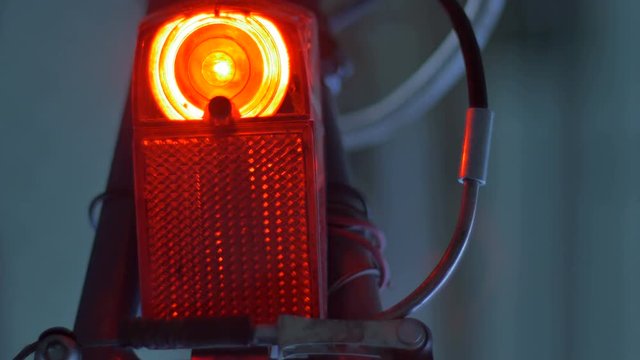 Red tail light bulb powered by bicycle dynamo on low light time.