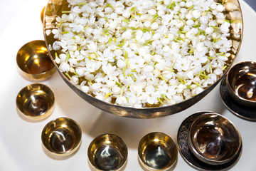 Fresh jasmine flowers in the brass with water