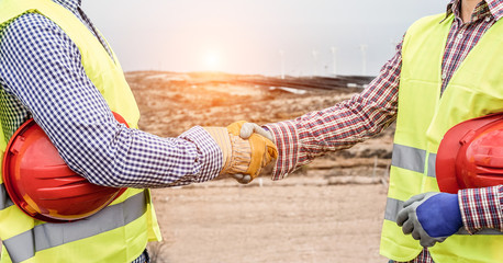 Builders on wind farm and photovoltaic plant site making a deal