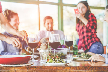 Happy friends having a vegetarian dinner at home