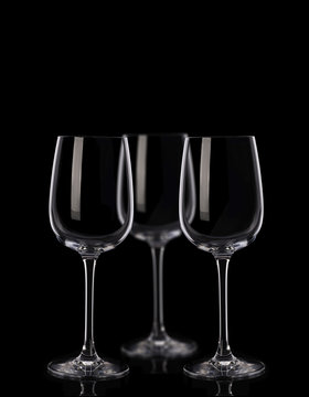 Three wine glasses on black background