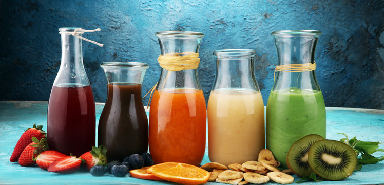 Selection of colorful smoothies on rustic background