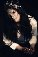 Girl with a stylized make-up of a dead bride