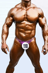 Fototapeta premium PUNE, MAHARASHTRA, INDIA, 29th March 2018, Young bodybuilder showing chest muscles in front pose Indian Body Builders Association show, Balewadi, Baner