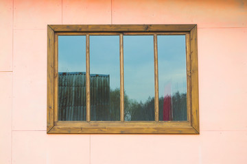 деревянное окно на розовой стене
