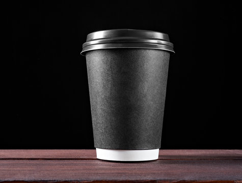 Black paper coffee cup Isolated on black background. Coffee - take out, to go, take away.