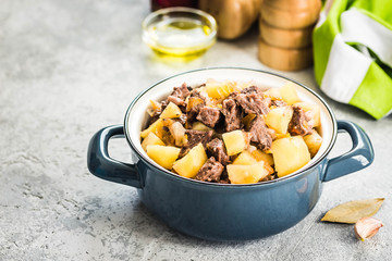 Instant pot beef potato stew in a pot on concrete background. Selective focus, space for text.