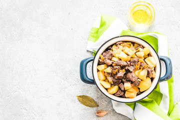 Instant pot meat potato stew on concrete background. Top view, space for text.
