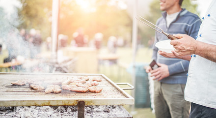 Man cooking meat at dinner barbecue
