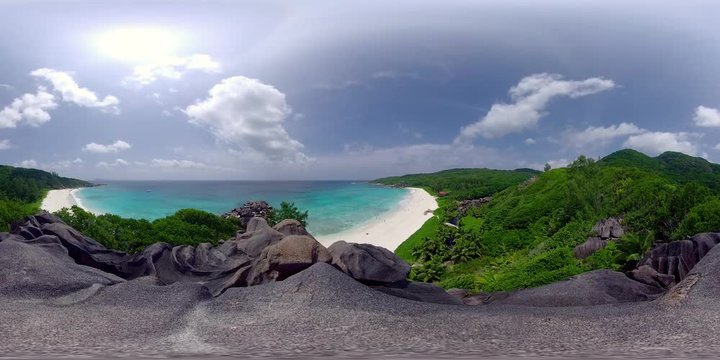 360 degree virtual reality high angle 4k view on granite rocks of tropical island with white sand beach and turquoise ocean on sunny vacation day, recorded in 8K
