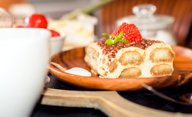 Tiramisu - Classical Dessert Garnished with Strawberry and Mint