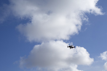 Fototapeta na wymiar Flying drone, isolated against blue sky