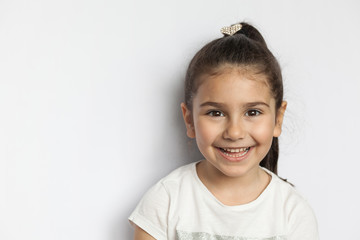 Portrait of happy cute brunette child  girl on white background - Powered by Adobe