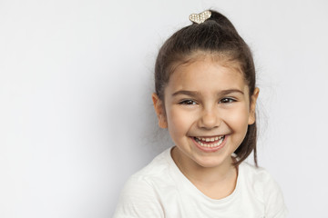 Portrait of happy cute brunette child  girl on white background